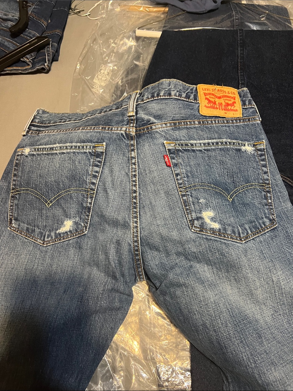 Levi's Men's Light-Mid Blue Straight Jeans with Subtle Distress